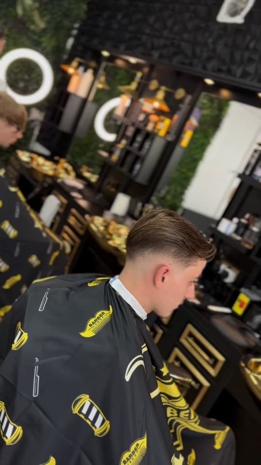 Side-parted cut with a low fade, side profile